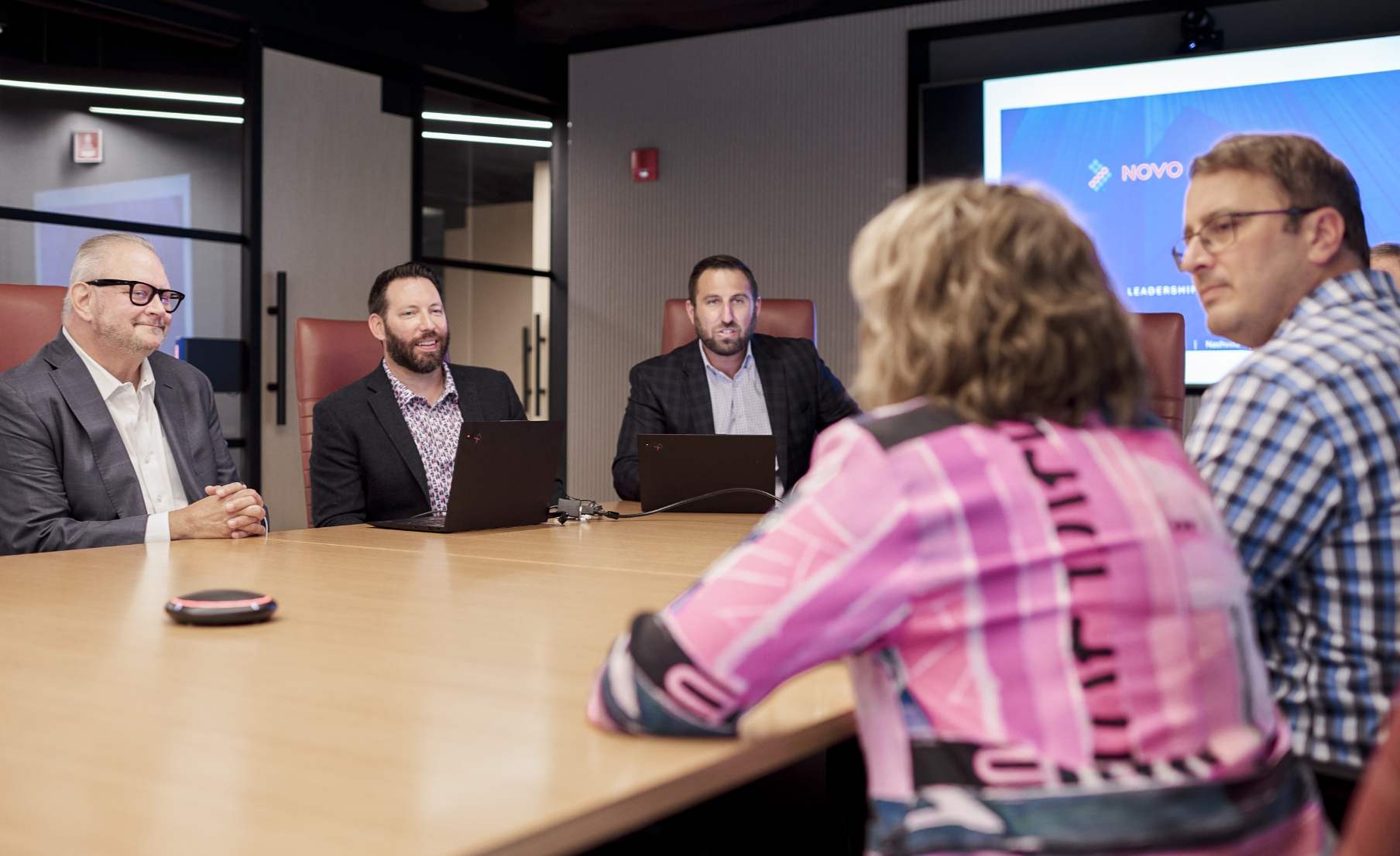 Novo Advisors meeting giving a presentation in a conference room